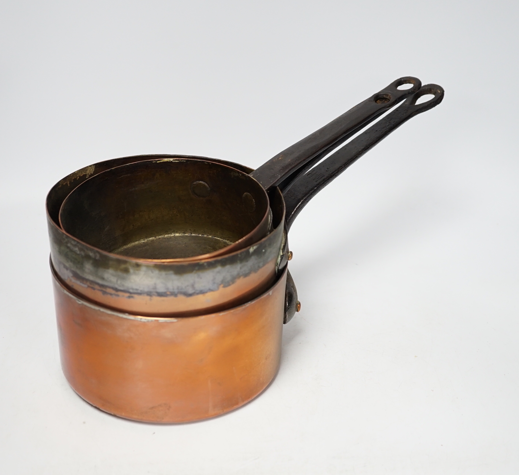 A set of six graduated copper saucepans